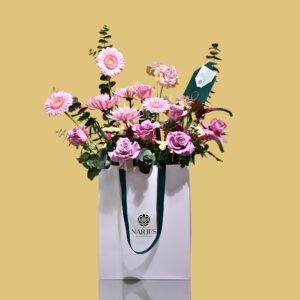 purple & pink rose & gerbera bouquet in white bag