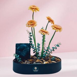 elegant floral & gift arrangement on black oval leather tray