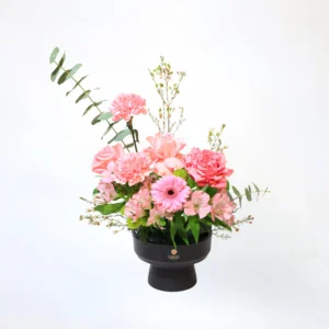 luxury pink floral display with wax flowers in black vase