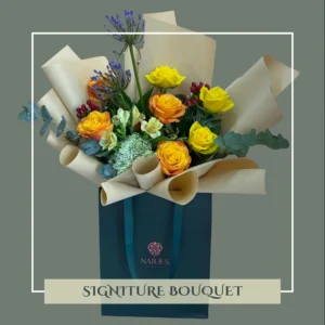 signature green bag bouquet – yellow & orange roses with floral mix