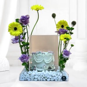 blooming petals and sweet cake featuring vibrant yellow gerberas and purple roses on clear acrylic tray